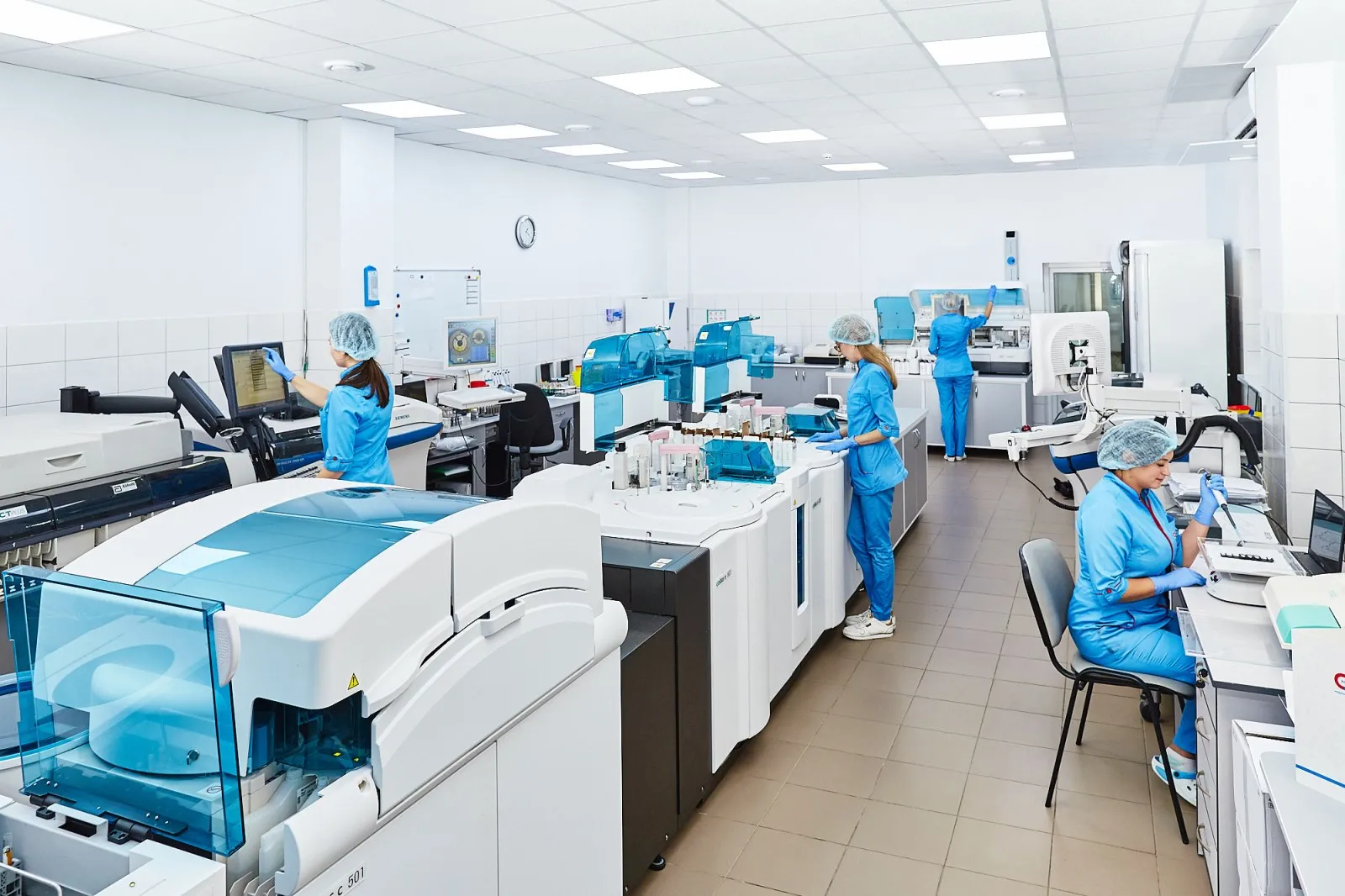 Research scientists in laboratory coats working together at a laboratory bench