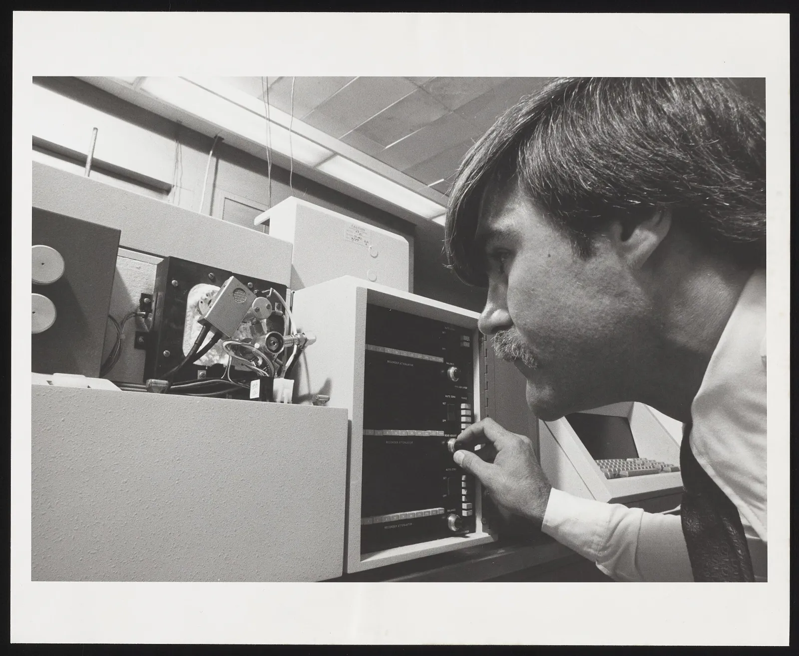 Laboratory scientist operating a gas chromatography system with analytical instruments and sample equipment